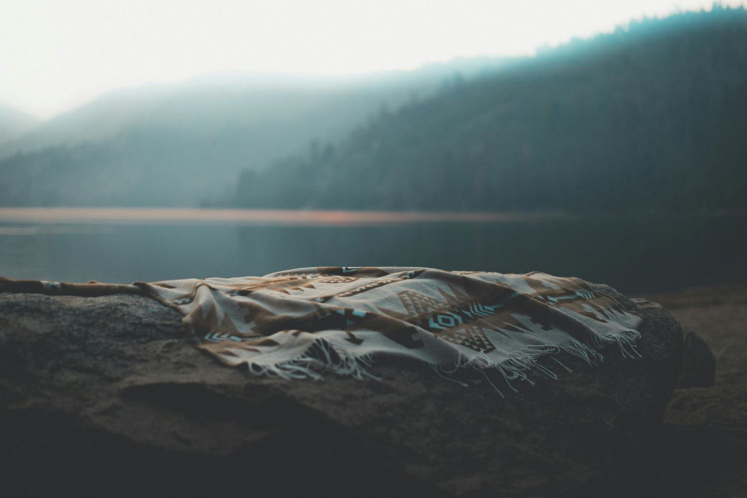 Fog on lake with Gideon's fleece on a rock.