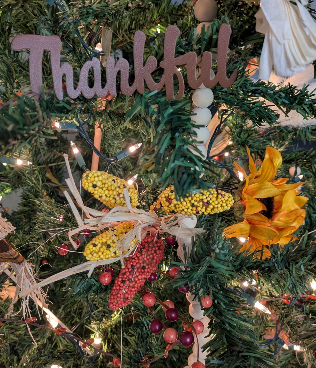 Word thankful with greenery and sunflower