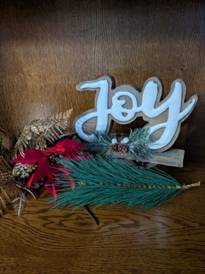 Joy with greenery and red flower